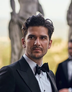 Short, wavy hair styled in a sophisticated updo, featuring a rich dark color, suitable for formal events or weddings.