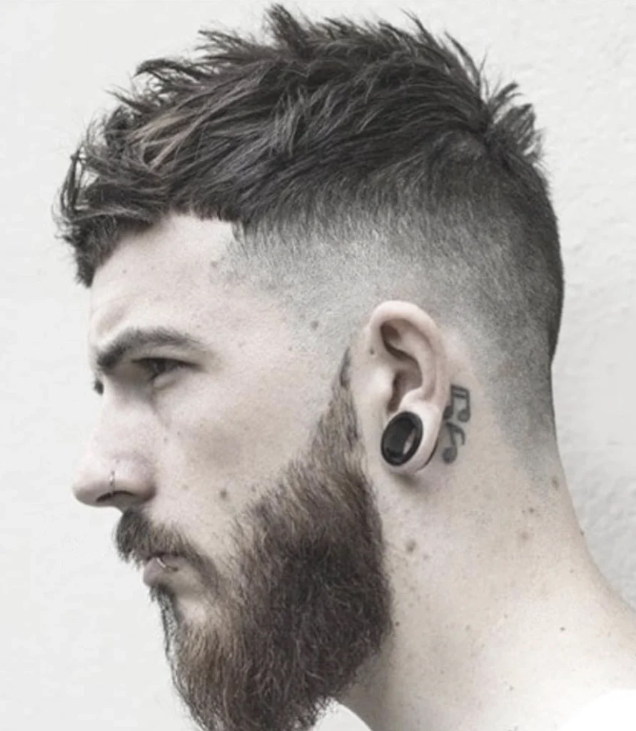 Short, textured hair on top with faded sides. Dark brown color; suitable for casual or trendy occasions.