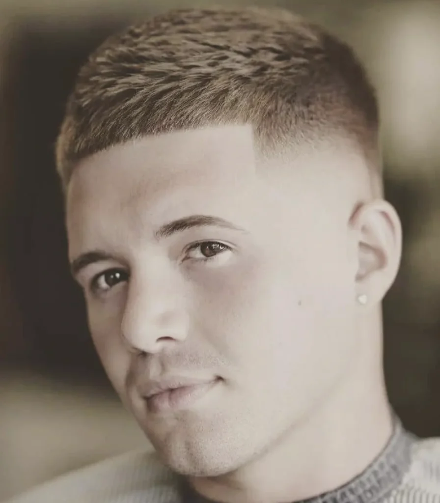 Short, textured hair in a cropped style with a clean fade, suitable for casual or formal occasions.