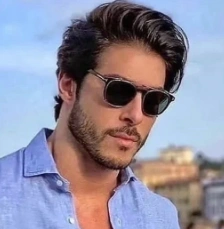 Medium-length, wavy hair styled casually with volume; dark brown color; suitable for casual and semi-formal occasions.